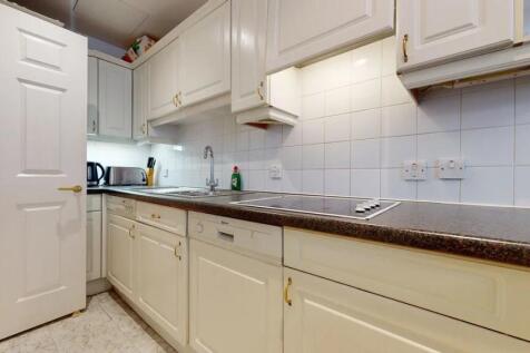 Bright and clean kitchen featuring ample cabine...