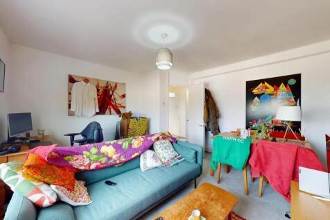 A bright and cozy living room featuring a comfo...