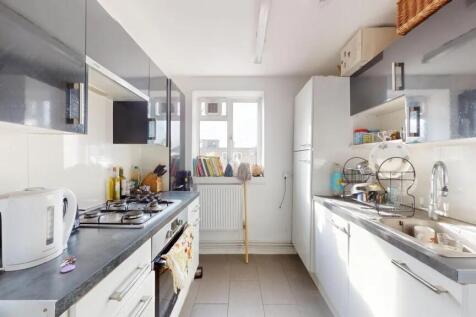 Bright and modern kitchen featuring sleek cabin...