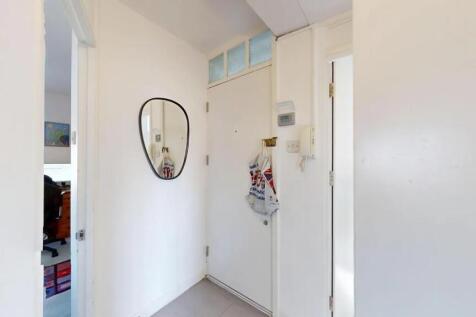 Bright and clean hallway with white walls, a wa...