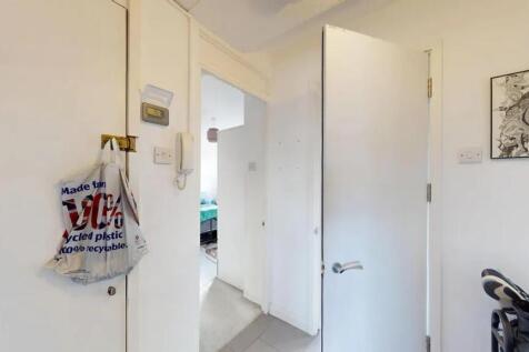 A neat and bright hallway with white walls and ...