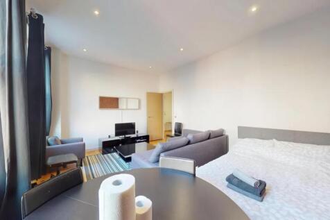 Bright and spacious master bedroom featuring a ...