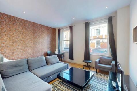Bright and modern living room featuring a styli...