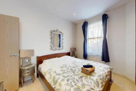 Bright and welcoming master bedroom with a larg...