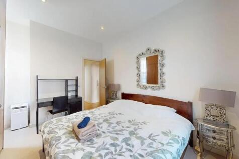 A bright and inviting double bedroom featuring ...