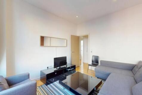 A bright and cozy living room featuring a spaci...