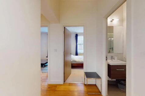 Bright and clean hallway featuring warm wooden ...
