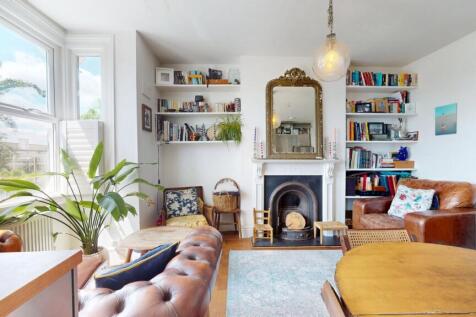 A bright and airy living room featuring large w...