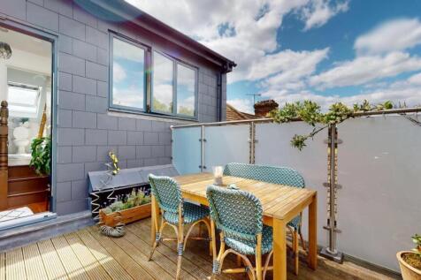A bright and inviting outdoor garden patio with...