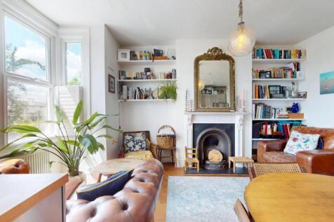 Bright and inviting living room featuring large...