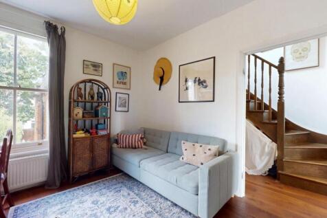 A charming living room with a large window offe...