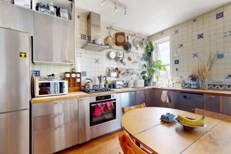 Bright and modern kitchen featuring stainless s...