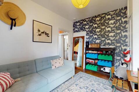 A bright and cozy living room featuring a comfo...