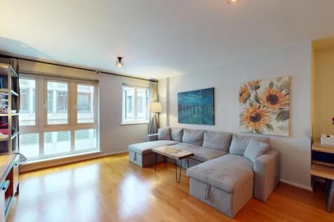 Bright and inviting living room with ample natu...