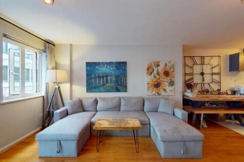 A cozy and contemporary living room featuring a...