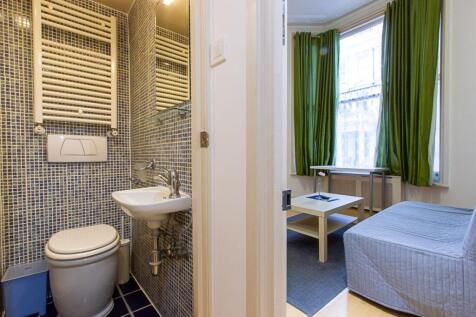 Compact and tidy small toilet room with modern ...