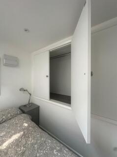 Bright and tidy single bedroom featuring a neat...