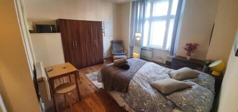 Bright and cozy double bedroom featuring a comf...