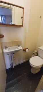 A compact and functional toilet room with a whi...