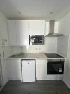 Bright and modern kitchen space featuring sleek...
