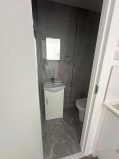 A modern bathroom featuring a sleek white sink ...
