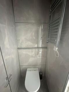 A sleek and modern single toilet with polished ...