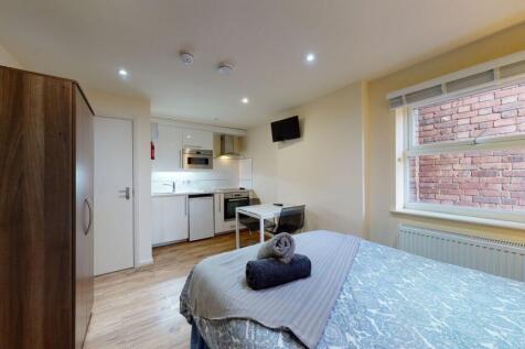 A cozy and modern single bedroom featuring a co...