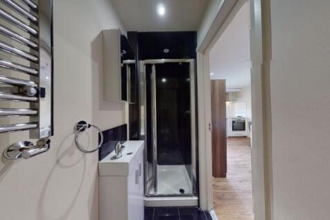 A modern bathroom featuring a sleek shower encl...
