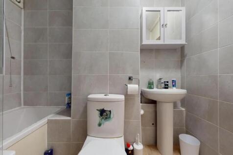A clean and modern bathroom suite featuring a b...