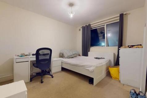 A cozy single bedroom featuring a comfortable b...