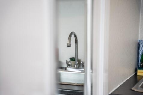 A well-maintained kitchen featuring a sleek sin...