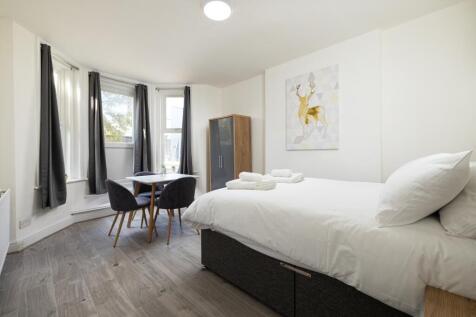 A bright and inviting double bedroom featuring ...