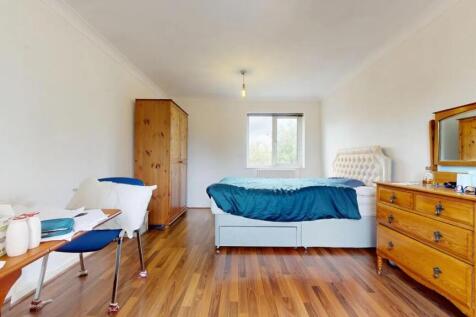 Bright double bedroom featuring a comfortable b...