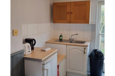 A functional kitchenette with ample storage and...