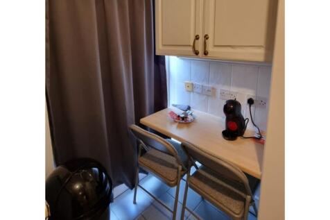 A cozy kitchenette with essential appliances, p...