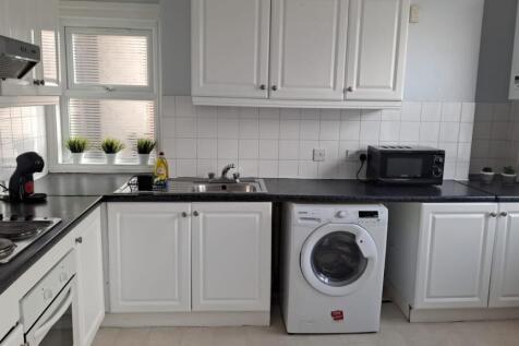 A bright and tidy kitchenette featuring modern ...