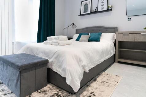 A modern double bedroom featuring a comfortable...