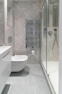 Modern bathroom featuring sleek marble walls an...