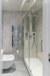 A modern, well-maintained bathroom featuring sl...