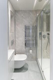 A sleek and modern bathroom featuring a spaciou...