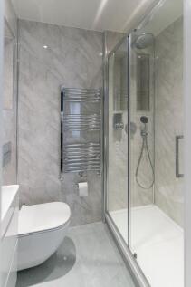 Bright and modern bathroom featuring sleek marb...