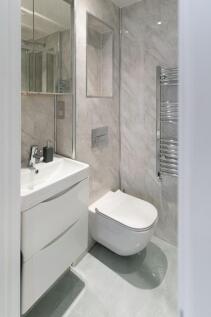A sleek and modern single toilet space featurin...