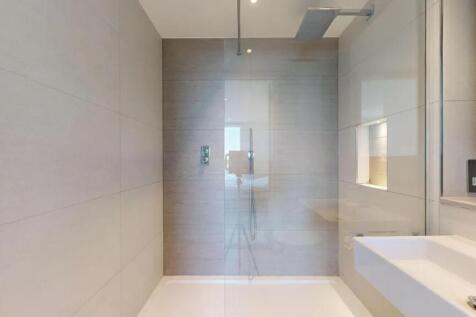 A sleek and modern bathroom featuring a spaciou...