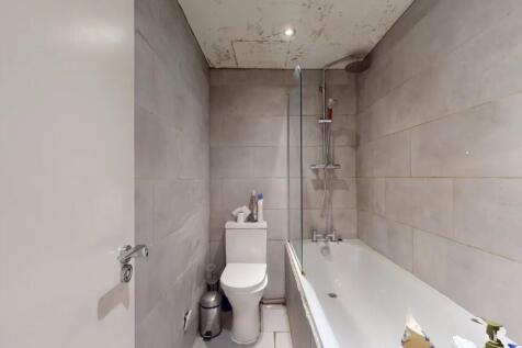 A modern bathroom featuring a clean white batht...