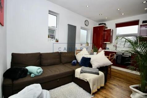 Cozy living room featuring a comfortable brown ...