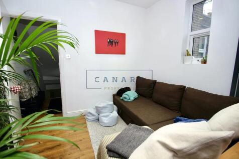 A cozy living room featuring a comfortable brow...