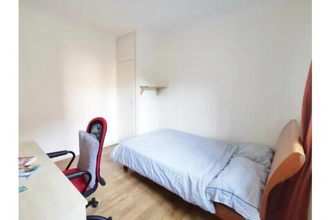 A bright and tidy single bedroom featuring a co...