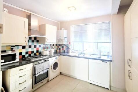 Bright and modern kitchen featuring colorful ti...