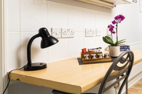 A bright and tidy kitchenette featuring modern ...