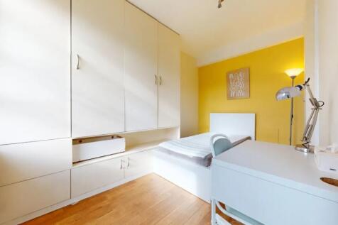 A bright and tidy single bedroom featuring a wh...